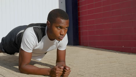 Young-Black-Man-Doing-Push-Ups-Before-Running-Outdoors