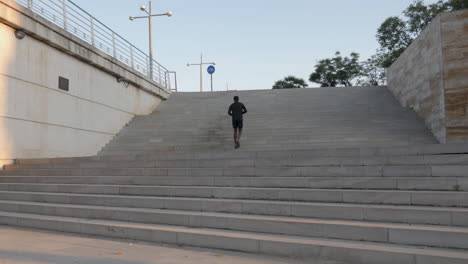 Young-Black-Runner-Man-Going-Up-Stairs-And-Training-For-Marathon-Outdoors
