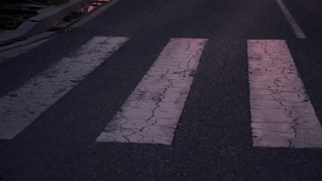 Close-Up-Of-Athlete-Crossing-A-Crosswalk-And-Running-In-The-City-At-Dusk