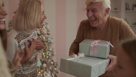 Grandpa-Taking-All-The-Christmas-Presents,-Joking-And-Laughing