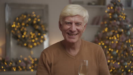 Old-Happy-Man-Toasting-And-Looking-At-The-Camera