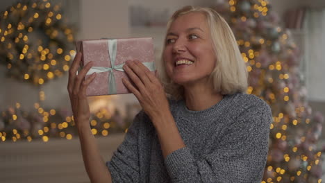 Od-Happy-Woman-Holding-A-Christmas-Present