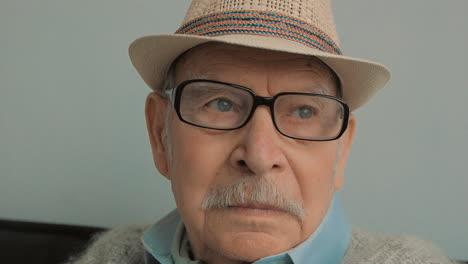 Portrait-Of-Elderly-Serious-Man-With-Gray-Mustache,-Hat,-Glasses-And-Cane