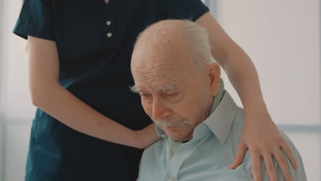 Portrait-Of-Emotional-Sad-Elderly-Man,-Caring-Nurse-Cheering-Up