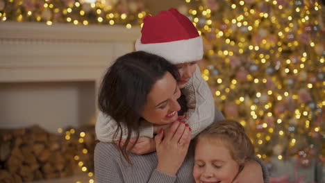 Mother,-Little-Boy-And-Girl-Hug-On-Christmas