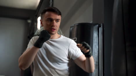 Strong-Athlete-Man-Workingout-And-Training-With-A-Punching-Bag