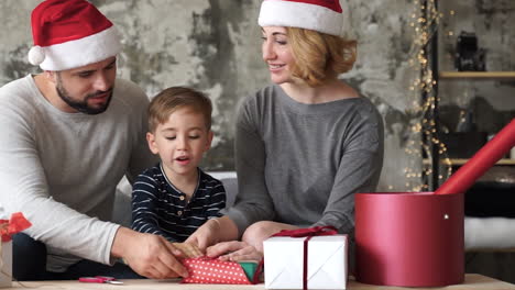 Mother,-Father-And-Little-Son-Prepare-Christmas-Gifts