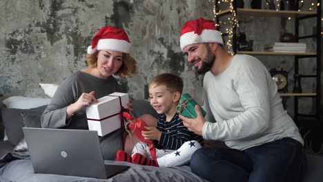 Mother,-Father-And-Little-Son-Having-Video-Call-With-Their-Family-Showing-Their-Christmas-Gifts