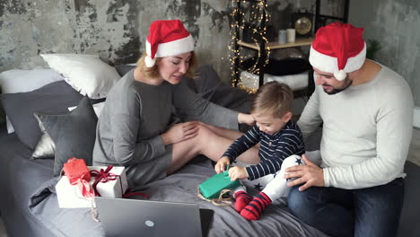 Mother,-Father-And-Little-Son-Having-Video-Call-With-Their-Family-And-Opening-Their-Christmas-Presents