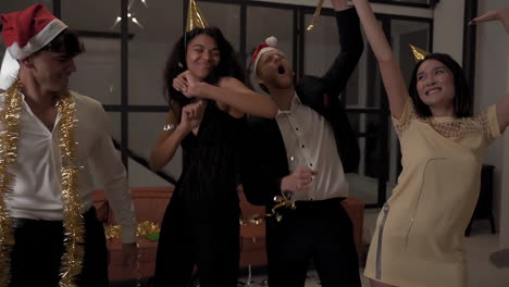 Female-And-Male-Happy-Friends-Dancing-With-Confetti-And-Celebrating-A-Party-At-Home