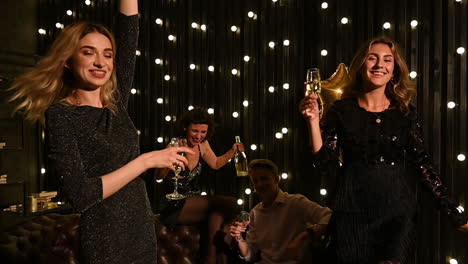 Young-Pretty-Women-Dancing-And-Toasting-With-Champagne-At-A-New-Year's-Eve-Party