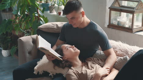 Young-Man-Reads-Book-To-Woman