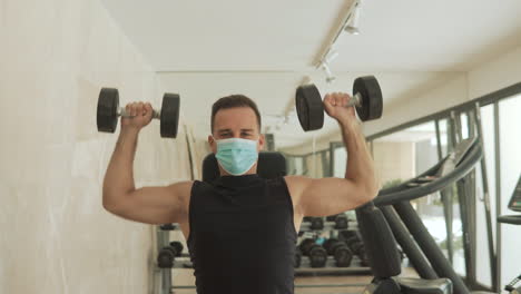 Young-Strong-Man-With-Face-Mask-Lifts-Weights-And-Exercises-In-The-Gym