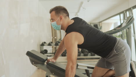 Young-Strong-Man-With-Face-Mask-Lifts-Weights-And-Exercises-In-The-Gym-1