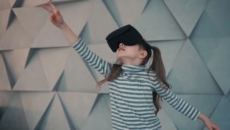 Little-Girl-With-Virtual-Reality-Glasses-Enjoying-A-Video-Or-Interactive-Game