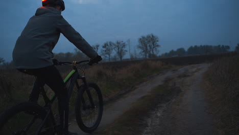Athlete-Male-Cyclist-Riding-A-Mountain-Bike-In-The-Countryside-At-Night