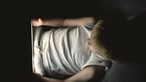 Little-Boy-Using-A-Tablet-Watching-A-Movie-Covered-By-The-Bed-Sheet-At-Night-1