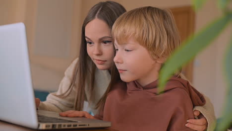 Kleiner-Junge-Und-Weiblicher-Teenager,-Der-Einen-Film-Mit-Laptop-Anschaut-Und-Zu-Hause-Spaß-Hat