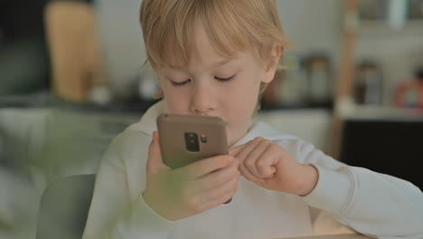 Child-With-Phone-Using-Apps-At-Home
