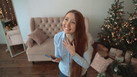 Excited-Woman-Using-A-Phone-At-Home