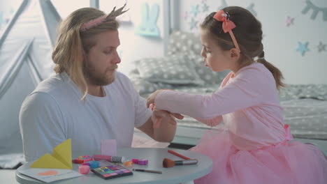 Close-Up-Of-Little-Daughter-And-Daddy-Dressed-As-Princesses-Playing-At-Home