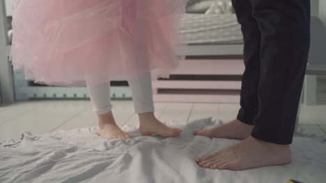 Little-Daughter-Dances-On-Her-Daddy's-Feet-At-Home