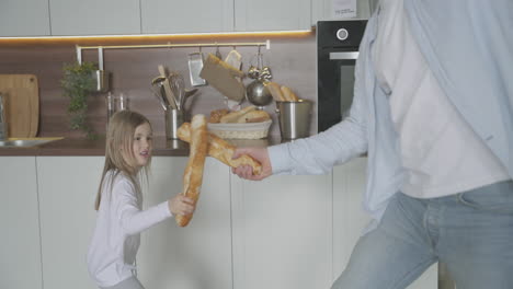 Dad-And-Daughter-Play-With-Food-At-Home