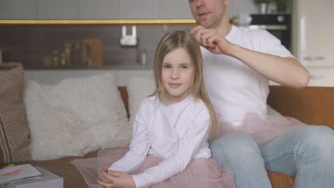 Dad-Combing-His-Little-Daughter's-Hair-At-Home