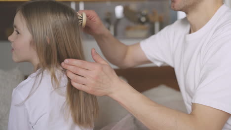 Dad-Combing-His-Little-Daughter's-Hair-At-Home-1
