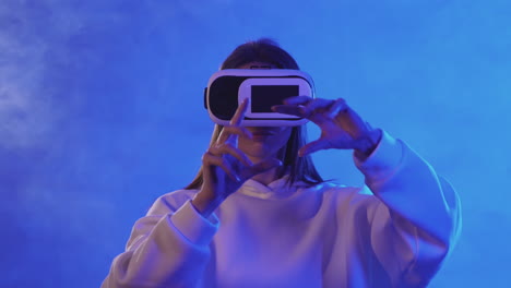 Young-Woman-Using-A-Vr-Headset-On-A-Colorful-Neon-Light-Background-1