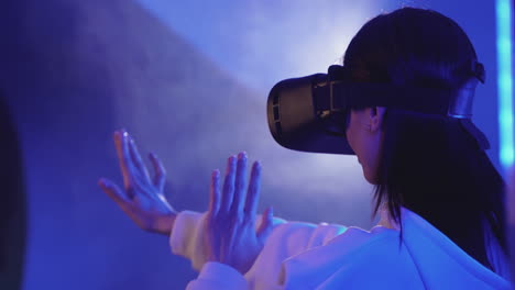 Modern-Female-Using-A-Vr-Headset-On-A-Colorful-Neon-Light-Background
