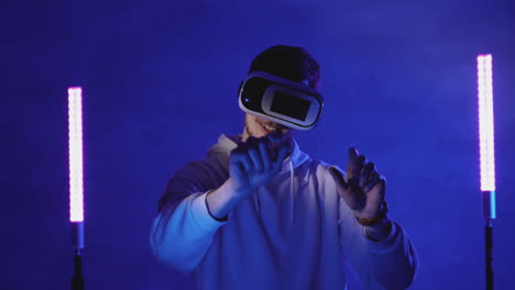 Male-Using-A-Vr-Headset-On-A-Colorful-Neon-Light-Background