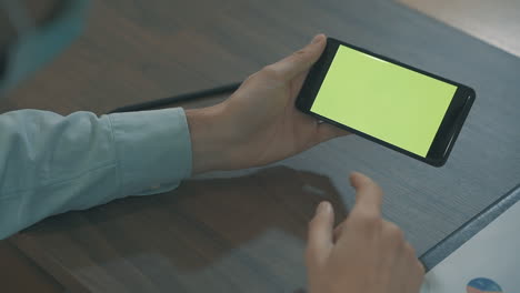 Close-Up-Of-Hands-Using-A-Green-Screen-Smartphone