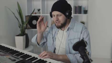 Youn-Man-Musician-Singing-And-Playing-Electric-Keyboard-At-Home