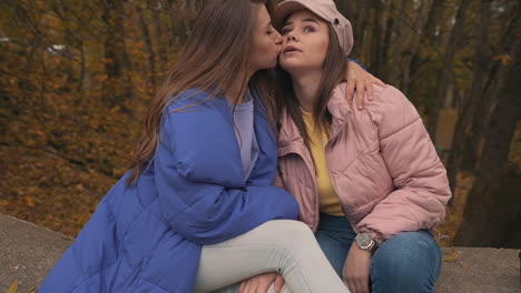 Young-Female-Friends-Kissing-And-Hugging-Outside