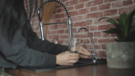Filling-Glass-Of-Water-On-The-Kitchen-Faucet
