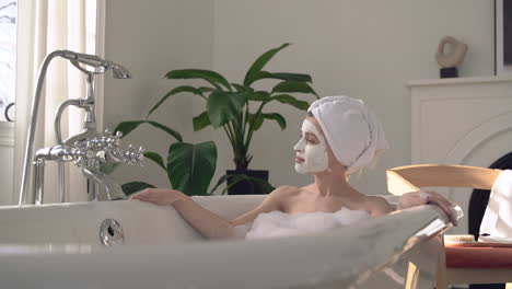 Female-With-Face-Mask-Taking-A-Relaxing-Bath
