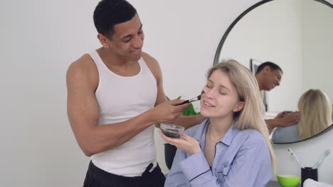 Handsome-Black-Man-Applying-Facial-Mask-To-A-Woman