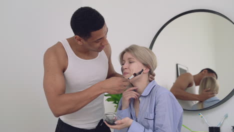 Handsome-Black-Male-Applying-Facial-Mask-To-A-Female
