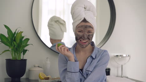 Woman-With-Facial-Mask-And-A-Lemon-Looking-To-The-Camera