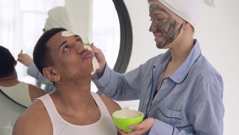 Woman-Applying-Facial-Mask-To-A-Handsome-Black-Man-1