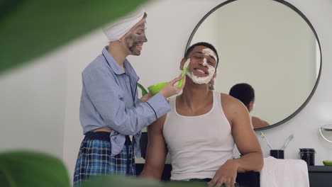 Woman-With-Facial-Mask-Applying-Scrub-To-A-Handsome-Black-Man