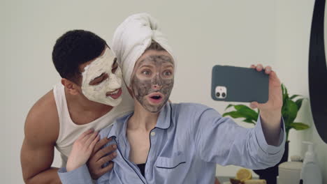 Interrassisches-Paar-Mit-Gesichtsmaske,-Das-Ein-Selfie-Macht-1