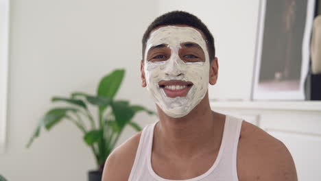 Portrait-Of-A-Handsome-Black-Male-With-Facial-Mask-Looking-At-Camera-And-Smiling