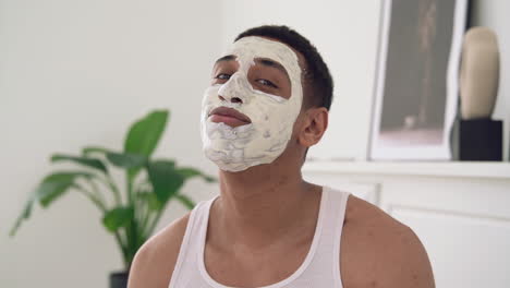 Portrait-Of-A-Handsome-Black-Man-With-Facial-Mask-Looking-At-Camera-And-Smiling-1