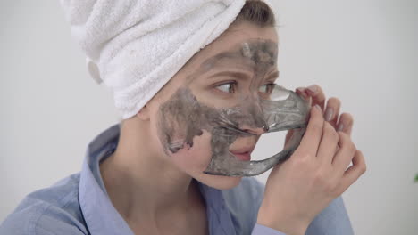 Portrait-Of-Woman-Removing-Facial-Mask