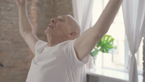Old-Man-Stretching-And-Exercising-At-Home-1