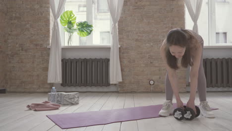 Old-Woman-Sitting-On-Yoga-Mat-At-Home