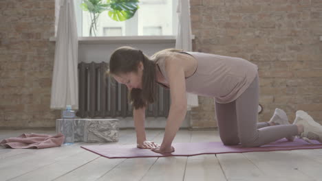 Old-Woman-Doing-Push-Ups-On-Yoga-Mat-At-Home