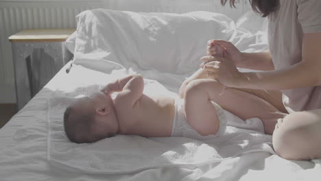Cute-Baby-And-Happy-Mom-In-Bed